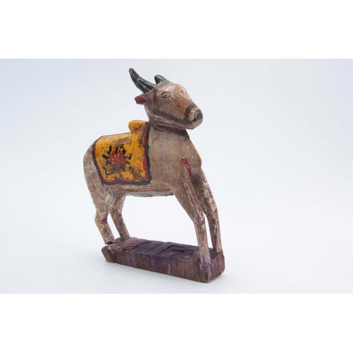 502 - A CARVED AND PAINTED HINDU NANDI COW 31cm high 20cm wide