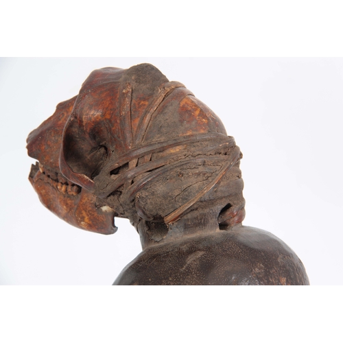 504 - A LATE 19TH CENTURY AFRICAN CARVED FIGURE with monkey skull head on stained wooden body - 39cm high