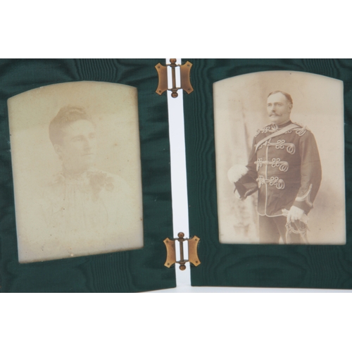 517 - AN EARLY 20TH CENTURY BLACK ALLIGATOR SKIN FOLDING TRAVELLING PHOTO FRAME with black and white photo... 