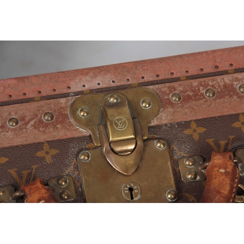 519 - A VINTAGE LOUIS VUITTON BROWN LEATHER SUITCASE with studded brass corner mounts and angle straps to ... 