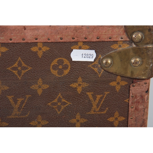 519 - A VINTAGE LOUIS VUITTON BROWN LEATHER SUITCASE with studded brass corner mounts and angle straps to ... 