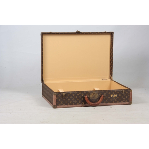 520 - A VINTAGE LOUIS VUITTON BROWN LEATHER SUITCASE with studded brass corner mounts, fasteners and lock ... 