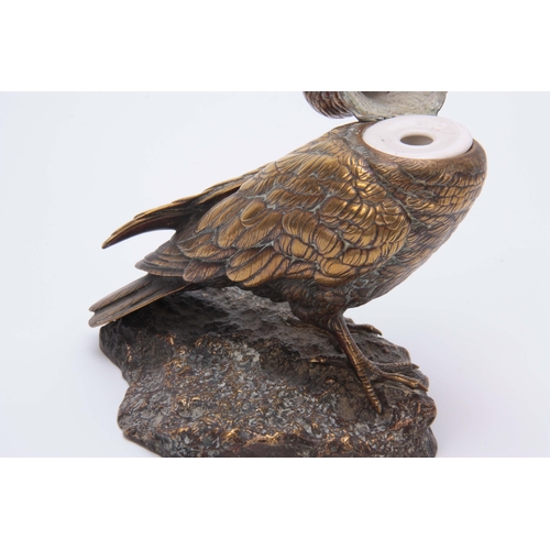 532 - A LATE 19th CENTURY AUSTRIAN BRONZE INKWELL modelled as a carrier pigeon holding an envelope in its ... 