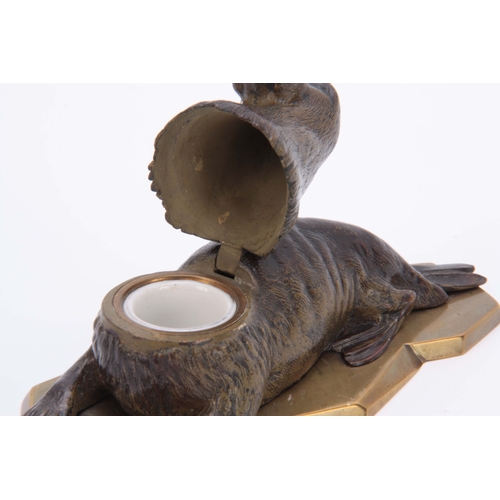 536 - A LATE 19th CENTURY AUSTRIAN COLD PAINTED BRONZE INKWELL formed as a walrus lying on a glacier style... 