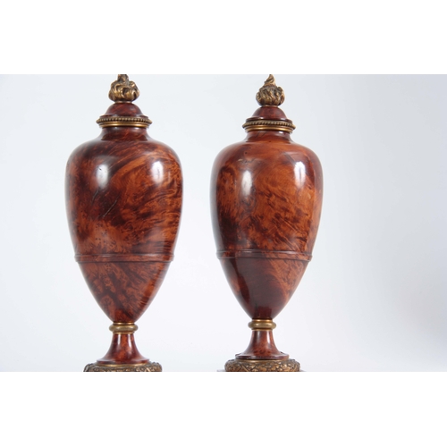 551 - A FINE PAIR OF 19TH CENTURY BURR YEW-WOOD ORMOLU MOUNTED URNS with flame finials and bulbous ringed ... 