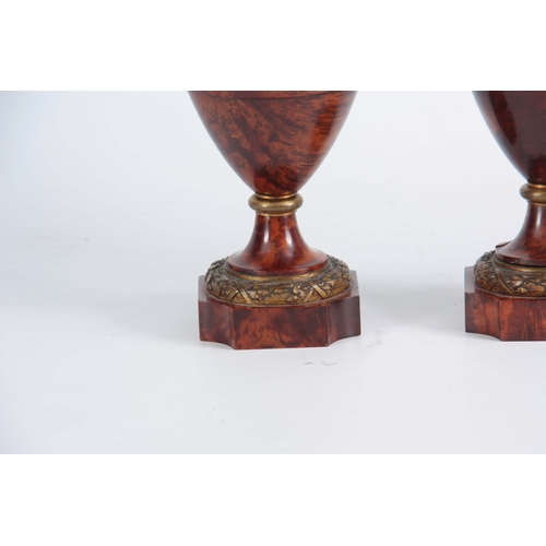 551 - A FINE PAIR OF 19TH CENTURY BURR YEW-WOOD ORMOLU MOUNTED URNS with flame finials and bulbous ringed ... 