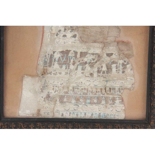 555 - A FRAGMENT OF ANTIQUE CLOTH WITH EGYPTIAN HIEROGLYPHICS - mounted in a later glazed frame 15cm high ... 