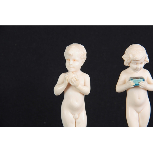 574 - FERDINAND PREISS (1882-1943). AN EARLY 20TH CENTURY PAIR OF SMALL IVORY SCULPTURES OF YOUNG BOYS EAT... 