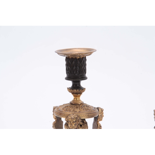 579 - A PAIR OF REGENCY BRONZE AND ORMOLU CANDLESTICKS / INCENSE BURNERS with removable scones and mask he... 