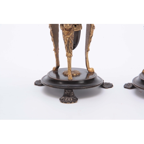 579 - A PAIR OF REGENCY BRONZE AND ORMOLU CANDLESTICKS / INCENSE BURNERS with removable scones and mask he... 