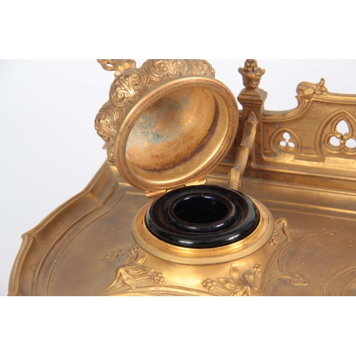 581 - A 19TH CENTURY GILT BRONZE PERSIAN STYLE INK WELL / DESK STAND with hinged Turkish domed top inkwell... 