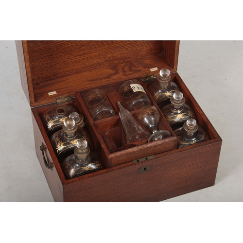 588 - A 19TH CENTURY OAK FITTED DECANTER SET comprising six large rectangular bottles and stoppers with gi... 