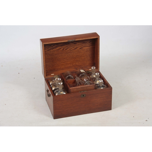 588 - A 19TH CENTURY OAK FITTED DECANTER SET comprising six large rectangular bottles and stoppers with gi... 