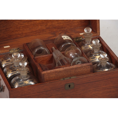 588 - A 19TH CENTURY OAK FITTED DECANTER SET comprising six large rectangular bottles and stoppers with gi... 