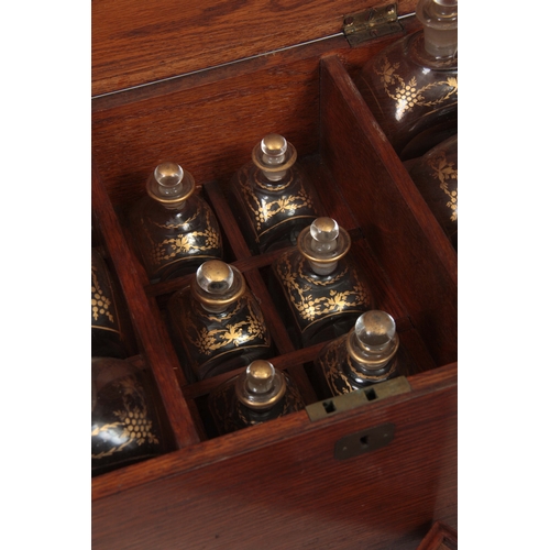 588 - A 19TH CENTURY OAK FITTED DECANTER SET comprising six large rectangular bottles and stoppers with gi... 