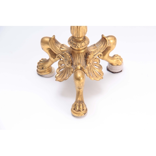 606 - A 19TH CENTURY FRENCH EMPIRE STYLE GILT BRASS CANDLESTICK with tapering reeded stem and leaf cast sc... 