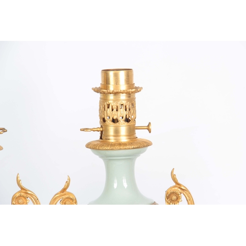 608 - A STYLISH PAIR OF LATE 19TH CENTURY FRENCH CELADON GLAZED PATE SUR PATE AND ORMOLU MOUNTED OIL LAMPS... 