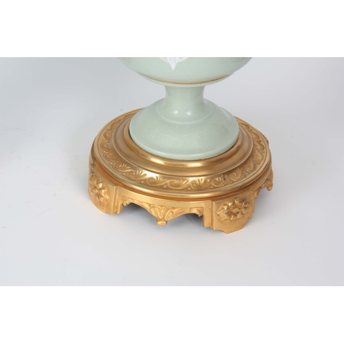 608 - A STYLISH PAIR OF LATE 19TH CENTURY FRENCH CELADON GLAZED PATE SUR PATE AND ORMOLU MOUNTED OIL LAMPS... 