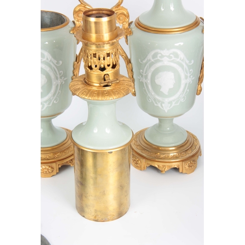 608 - A STYLISH PAIR OF LATE 19TH CENTURY FRENCH CELADON GLAZED PATE SUR PATE AND ORMOLU MOUNTED OIL LAMPS... 