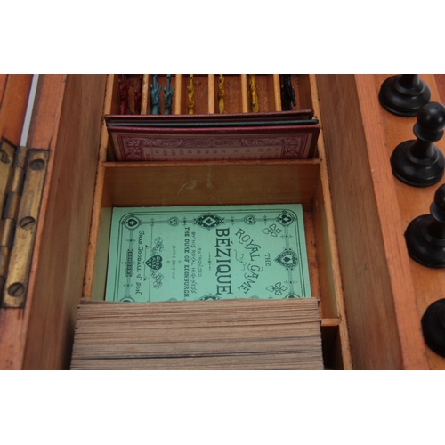 625 - A VICTORIAN MAHOGANY GAMES COMPENDIUM WITH JAQUES MONOGRAM having a hinged fold-out front and lid en... 