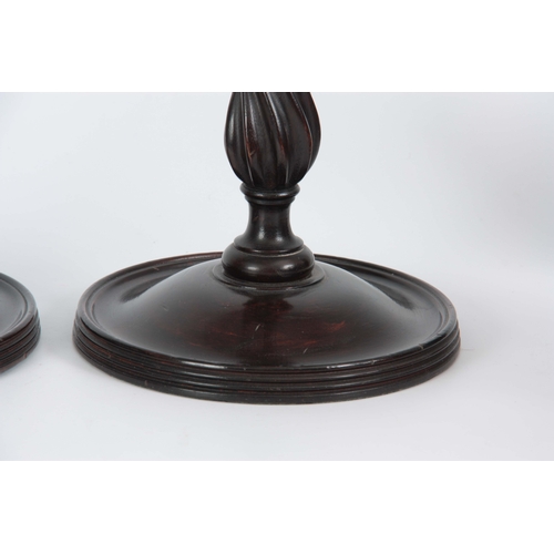 626 - A TALL PAIR OF GEORGIAN STYLE MAHOGANY CANDLESTICKS having cast brass leaf work sconces and tapered ... 