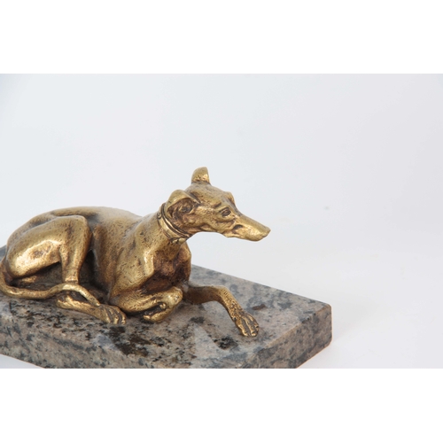 627 - AN EARLY 20th CENTURY GILT BRONZE SCULPTURE modelled as a recumbent greyhound mounted on a marble ba... 