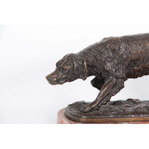 631 - A LATE 19th CENTURY PATINATED BRONZE SCULPTURE modelled as a gun dog standing on naturalistic base m... 