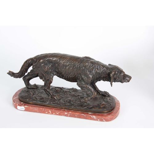 631 - A LATE 19th CENTURY PATINATED BRONZE SCULPTURE modelled as a gun dog standing on naturalistic base m... 