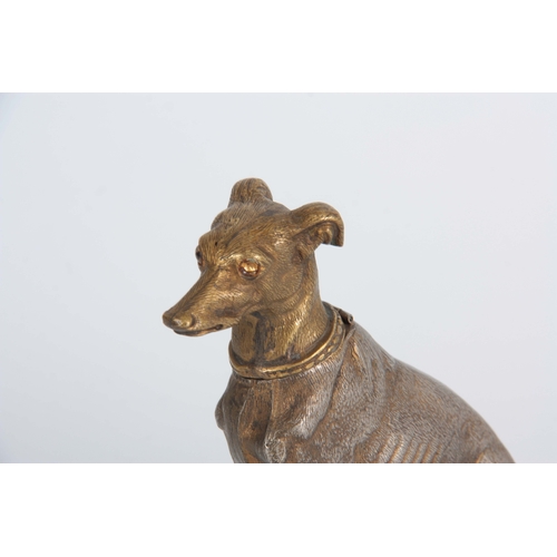 647 - A LATE 19th CENTURY NOVELTY INKWELL modelled as a gilt metal greyhound with amber glass eyes having ... 