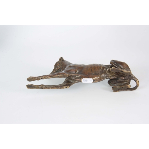 651 - A LATE 19th CENTURY PATINATED BRONZE SCULPTURE modelled as a recumbent greyhound 26cm long