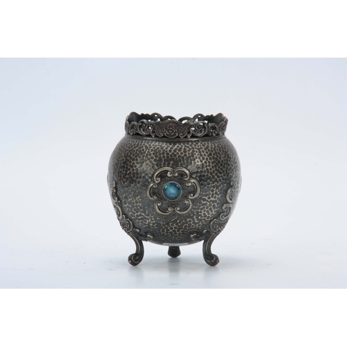 654 - AN EARLY 20TH CENTURY WHITE METAL VASE decorated with Ruskin jewels having planished finish with tri... 