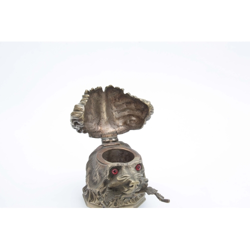 655 - A LATE 19th CENTURY CAST NICKLE NOVELTY INKWELL modelled as a dogs head with red glass eyes and hing... 