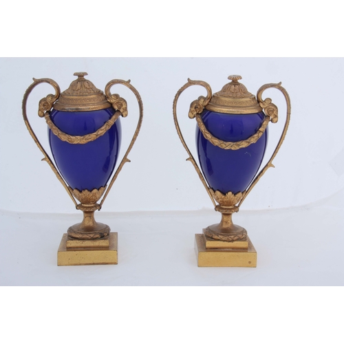 656 - A PAIR OF 19TH CENTURY FRENCH ORMOLU MOUNTED ROYAL BLUE PORCELAIN URN-SHAPED VASES with square stepp... 