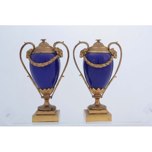 656 - A PAIR OF 19TH CENTURY FRENCH ORMOLU MOUNTED ROYAL BLUE PORCELAIN URN-SHAPED VASES with square stepp... 