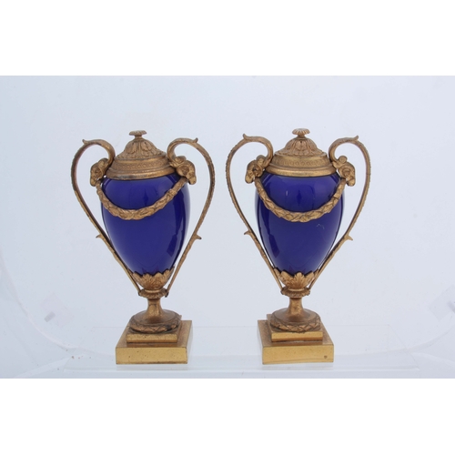 656 - A PAIR OF 19TH CENTURY FRENCH ORMOLU MOUNTED ROYAL BLUE PORCELAIN URN-SHAPED VASES with square stepp... 