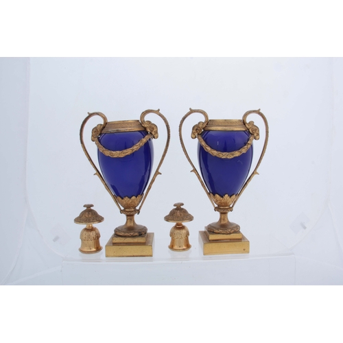 656 - A PAIR OF 19TH CENTURY FRENCH ORMOLU MOUNTED ROYAL BLUE PORCELAIN URN-SHAPED VASES with square stepp... 