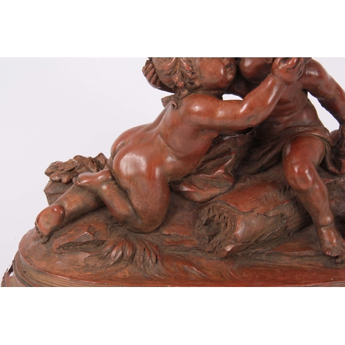 675 - A 19th CENTURY TERRACOTTA FIGURE GROUP modelled as putti on oval plinth with beaded edge 39cm wide -... 