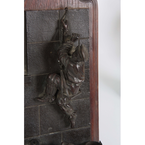 684 - A 19TH CENTURY FIGURAL BRONZE SPILL / VESTA WALL PLAQUE of a dog chasing a boy up a wall, mounted on... 