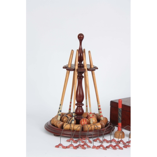 687 - A COMPLETE LATE 19th CENTURY TABLE CROQUET GAME having eight box wood mallets, and balls on a turned... 