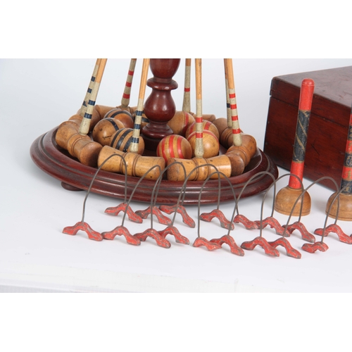 687 - A COMPLETE LATE 19th CENTURY TABLE CROQUET GAME having eight box wood mallets, and balls on a turned... 