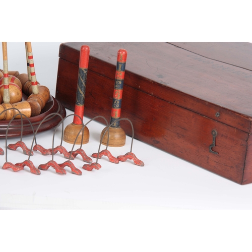 687 - A COMPLETE LATE 19th CENTURY TABLE CROQUET GAME having eight box wood mallets, and balls on a turned... 