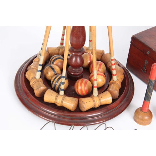 687 - A COMPLETE LATE 19th CENTURY TABLE CROQUET GAME having eight box wood mallets, and balls on a turned... 