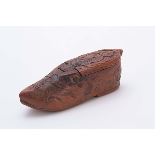 697 - AN EARLY 19TH CENTURY CARVED BOXWOOD FOLK ART SNUFF BOX IN THE SHAPE OF A SHOE decorated with figure... 