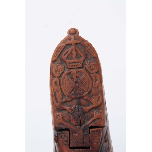 697 - AN EARLY 19TH CENTURY CARVED BOXWOOD FOLK ART SNUFF BOX IN THE SHAPE OF A SHOE decorated with figure... 