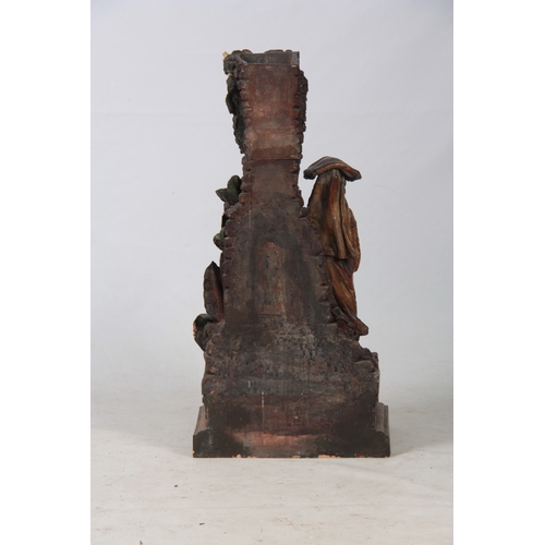 701 - A LATE 19TH CENTURY TERRACOTTA SCULPTURE OF A SPANISH LADY STOOD AT A WATER FOUNTAIN signed with ini... 