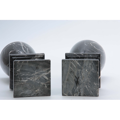 704 - A PAIR OF 20TH CENTURY  BLACK VEINED MARBLE URNS with shaped tops and plinth bases 48cm high.