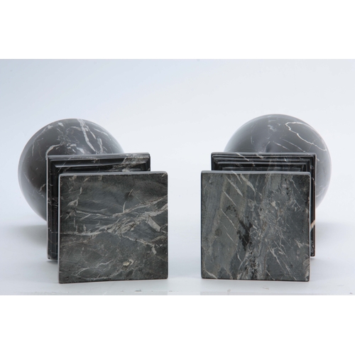 704 - A PAIR OF 20TH CENTURY  BLACK VEINED MARBLE URNS with shaped tops and plinth bases 48cm high.