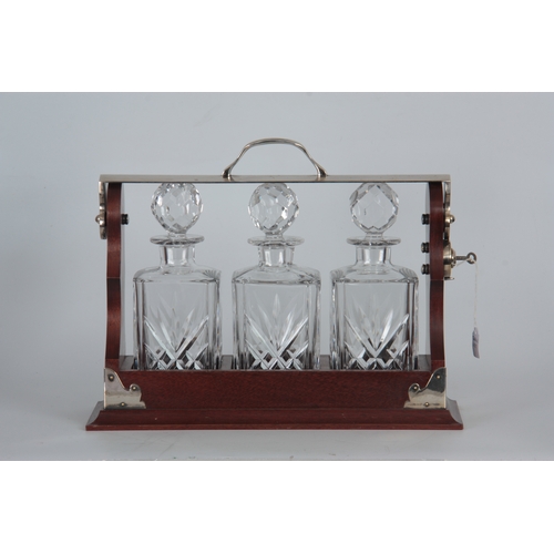 705 - A 20TH CENTURY MAHOGANY TANTULAS having a hinged silvered top fitted with a carrying handle, holding... 