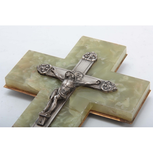 706 - AN EARLY 20TH CENTURY GREEN ONYNX AND SILVERED CRUCIFIX having a silvered cross mounted on a green m... 