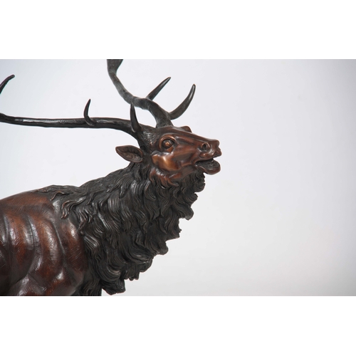 712 - A 20TH CENTURY BRONZE SCULPTURE OF AN IMPERIAL STAG standing on a naturalistic base 77cm wide 77cm h... 